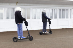 Electric scooters riding shotgun on pavement © Russell Jacobs